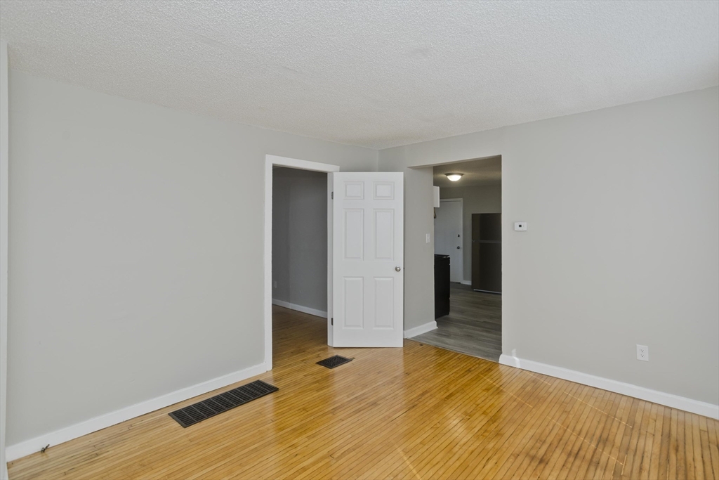 293 Eastern Avenue Springfield, MA 01109 - Photo 11 of 31 a view of an empty room with wooden floor and closet