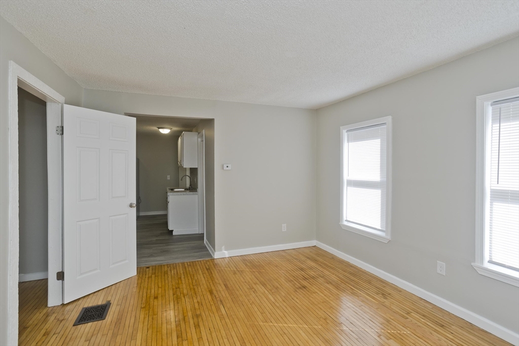 293 Eastern Avenue Springfield, MA 01109 - Photo 12 of 31 a view of empty room with wooden floor and window