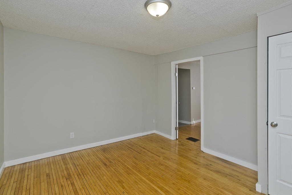 293 Eastern Avenue Springfield, MA 01109 - Photo 19 of 31 a view of empty room with wooden floor