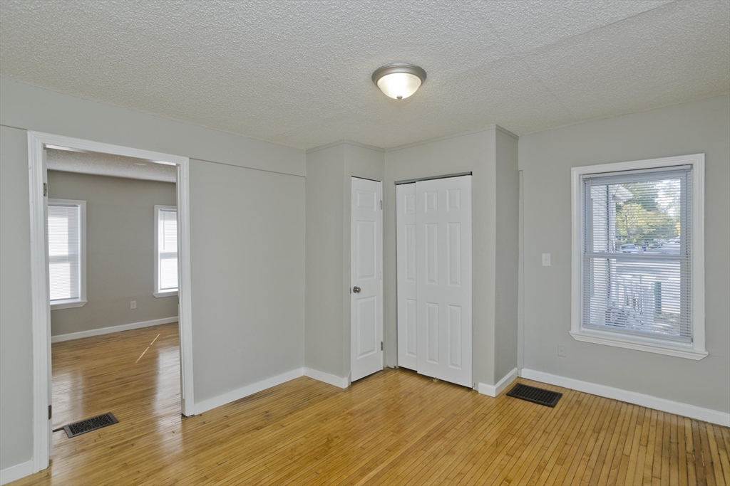 293 Eastern Avenue Springfield, MA 01109 - Photo 20 of 31 a view of empty room with wooden floor and fan