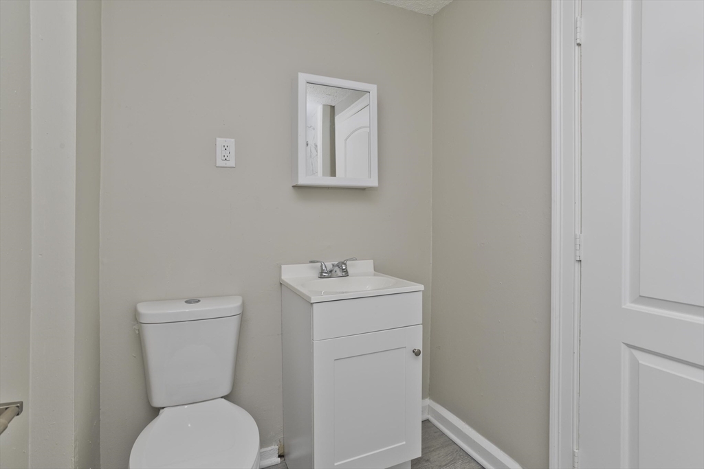 293 Eastern Avenue Springfield, MA 01109 - Photo 22 of 31 a bathroom with a toilet sink and mirror