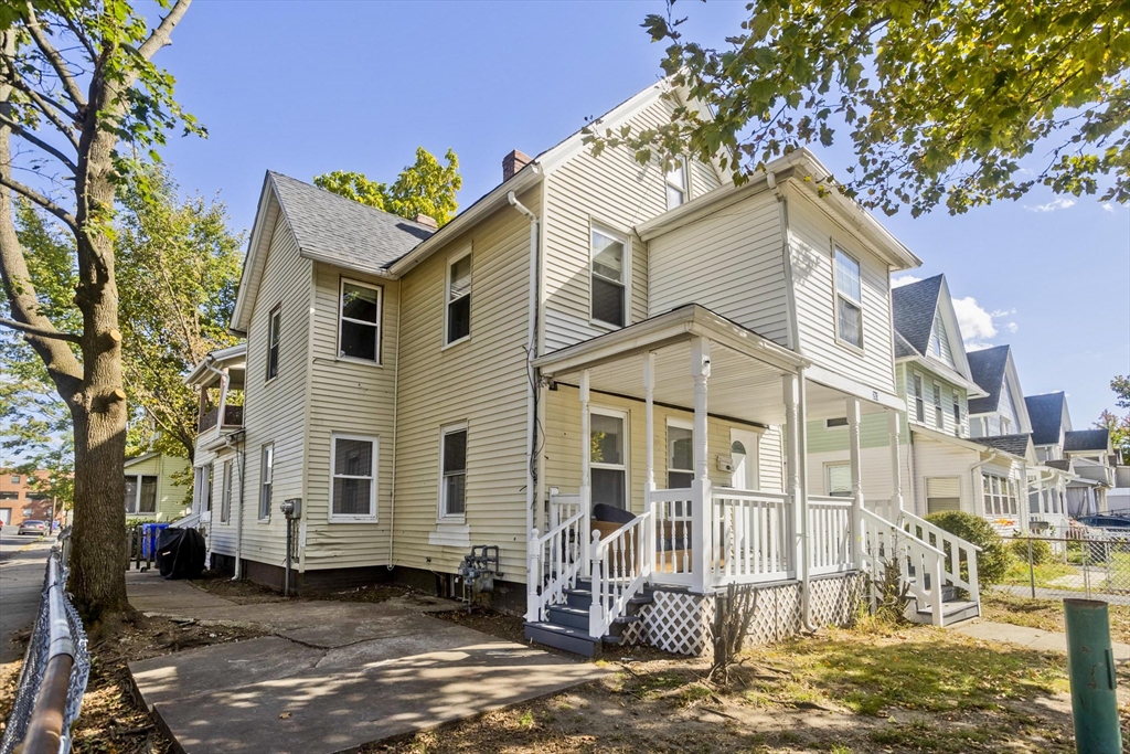 293 Eastern Avenue Springfield, MA 01109 - Photo 30 of 31 a view of a white house with large windows next to a road