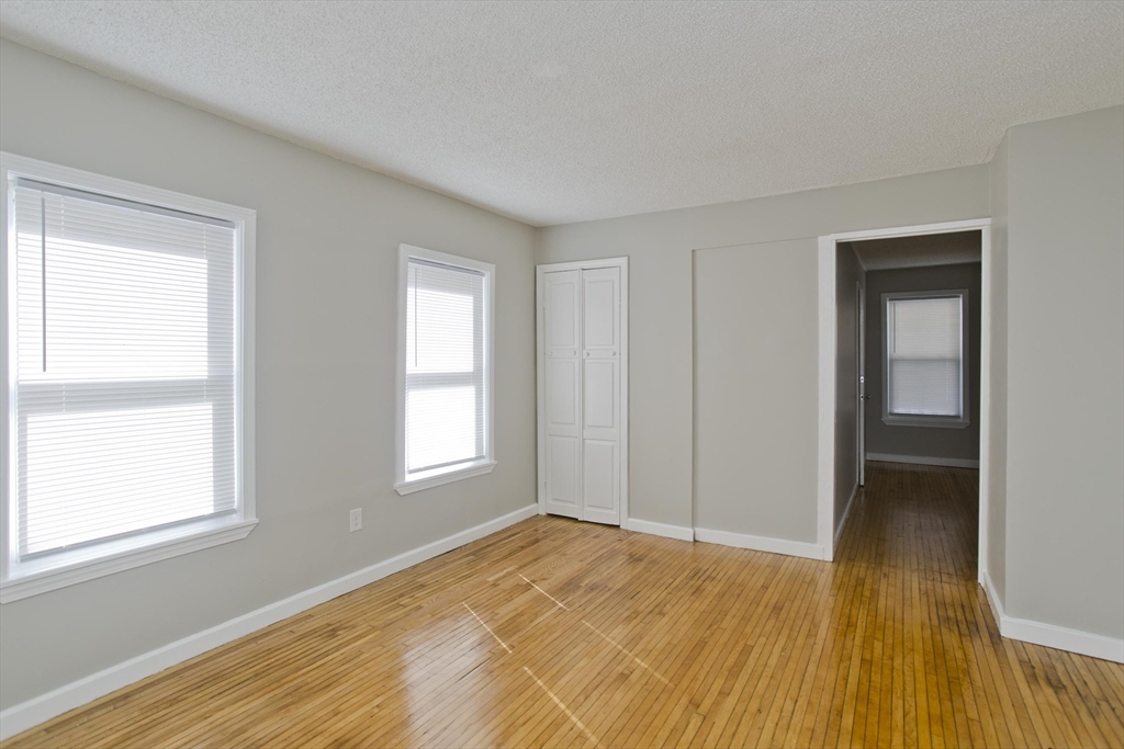 293 Eastern Avenue Springfield, MA 01109 - Photo 9 of 31 a view of empty room with wooden floor and fan