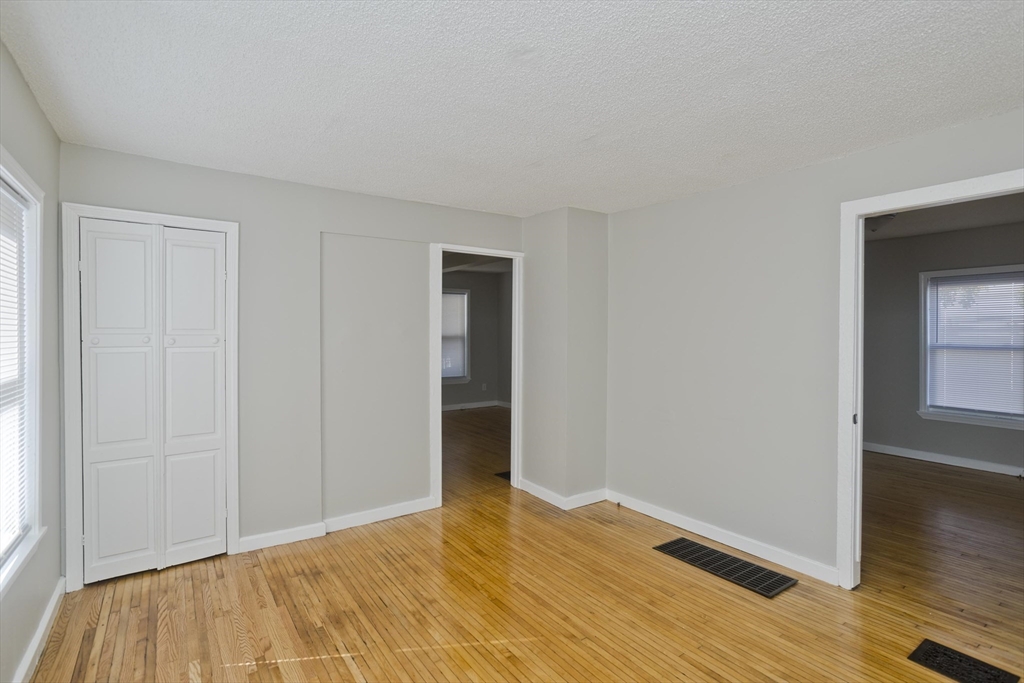 293 Eastern Avenue Springfield, MA 01109 - Photo 10 of 31 a view of empty room with wooden floor