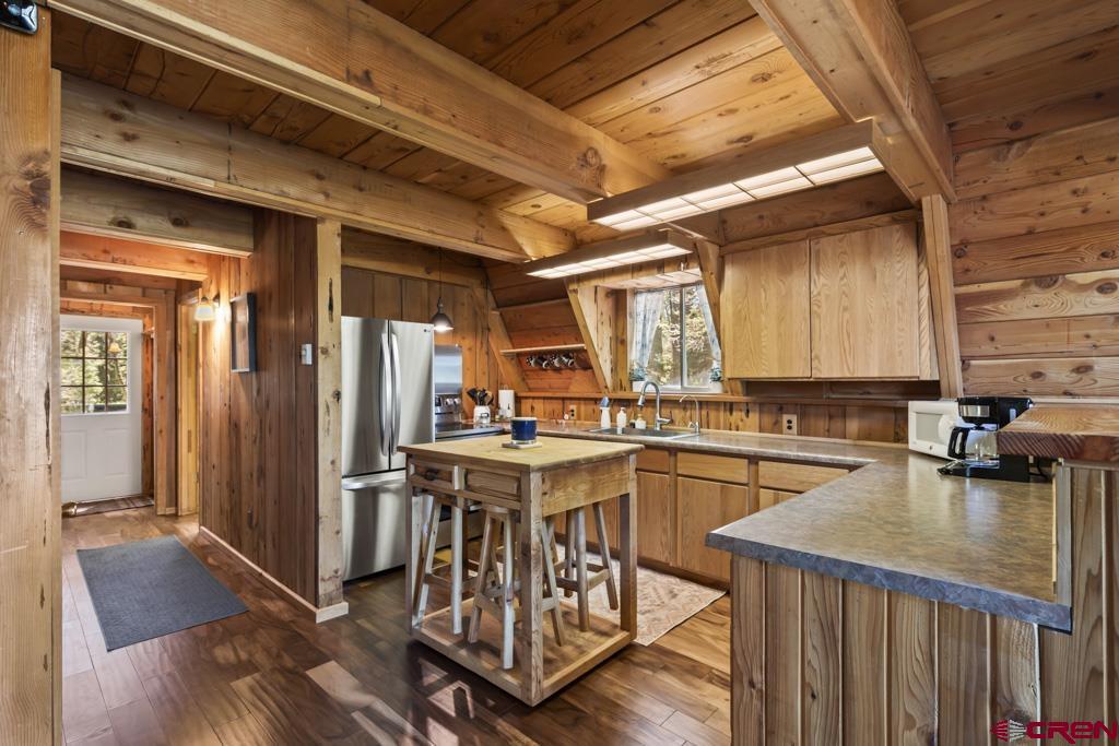 1201 Spruce Road Cimarron, CO 81220 - Photo 11 of 35 a kitchen with a stove a refrigerator and wooden cabinets