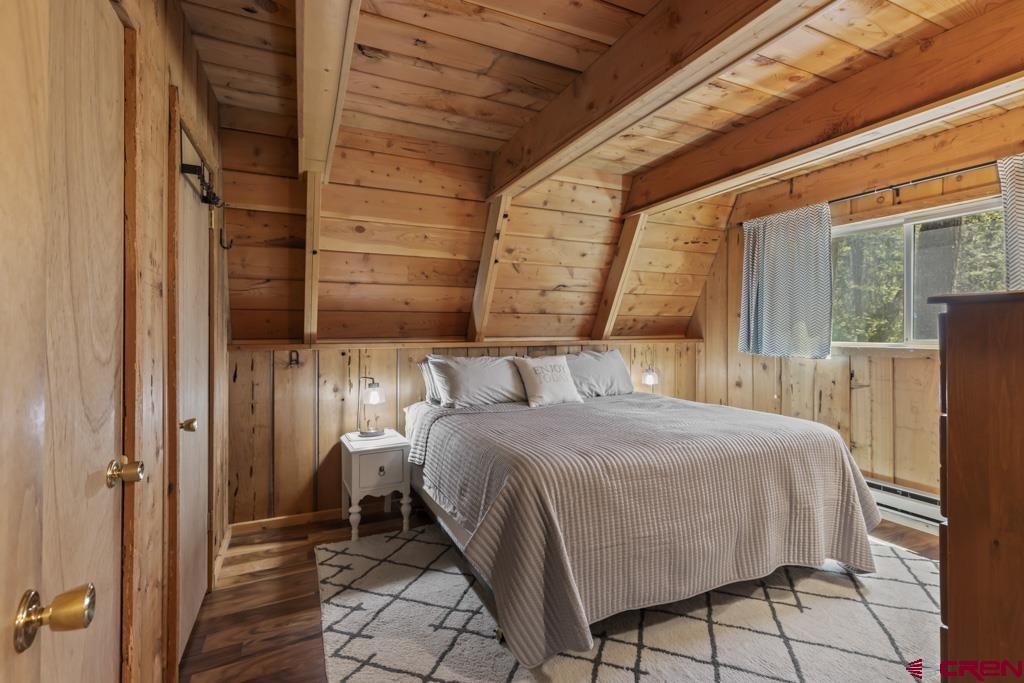 1201 Spruce Road Cimarron, CO 81220 - Photo 15 of 35 a bedroom with a bed and a window