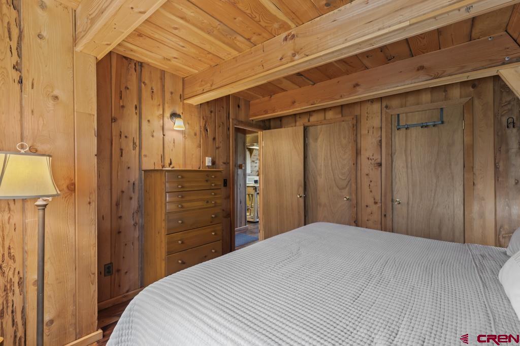 1201 Spruce Road Cimarron, CO 81220 - Photo 16 of 35 a bedroom with a bed and a closet