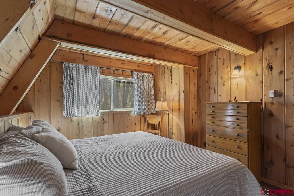 1201 Spruce Road Cimarron, CO 81220 - Photo 17 of 35 a bedroom with a bed and a window