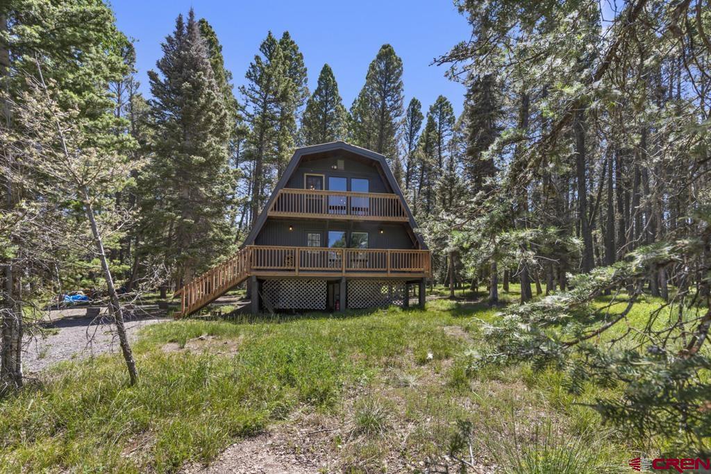1201 Spruce Road Cimarron, CO 81220 - Photo 2 of 35 a front view of a house with a garden