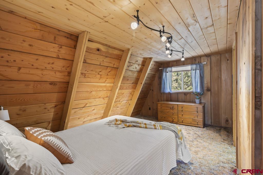 1201 Spruce Road Cimarron, CO 81220 - Photo 26 of 35 a bedroom with a bed and a window