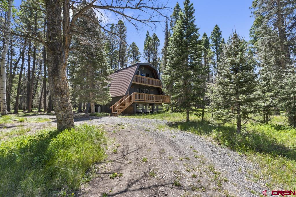 1201 Spruce Road Cimarron, CO 81220 - Photo 3 of 35 a front view of a house with a yard