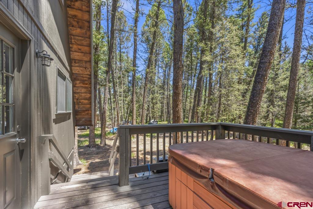 1201 Spruce Road Cimarron, CO 81220 - Photo 34 of 35 a balcony with wooden floor table and chairs