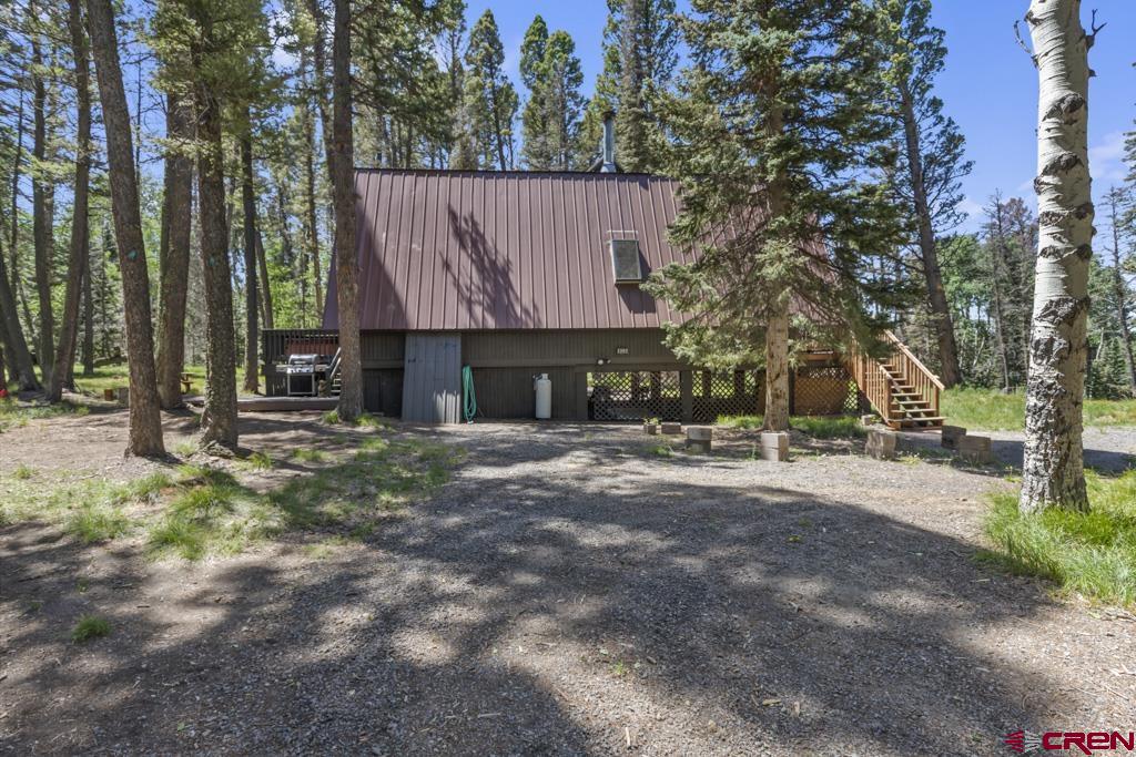 1201 Spruce Road Cimarron, CO 81220 - Photo 5 of 35 a view of backyard with table and chairs and a fire pit