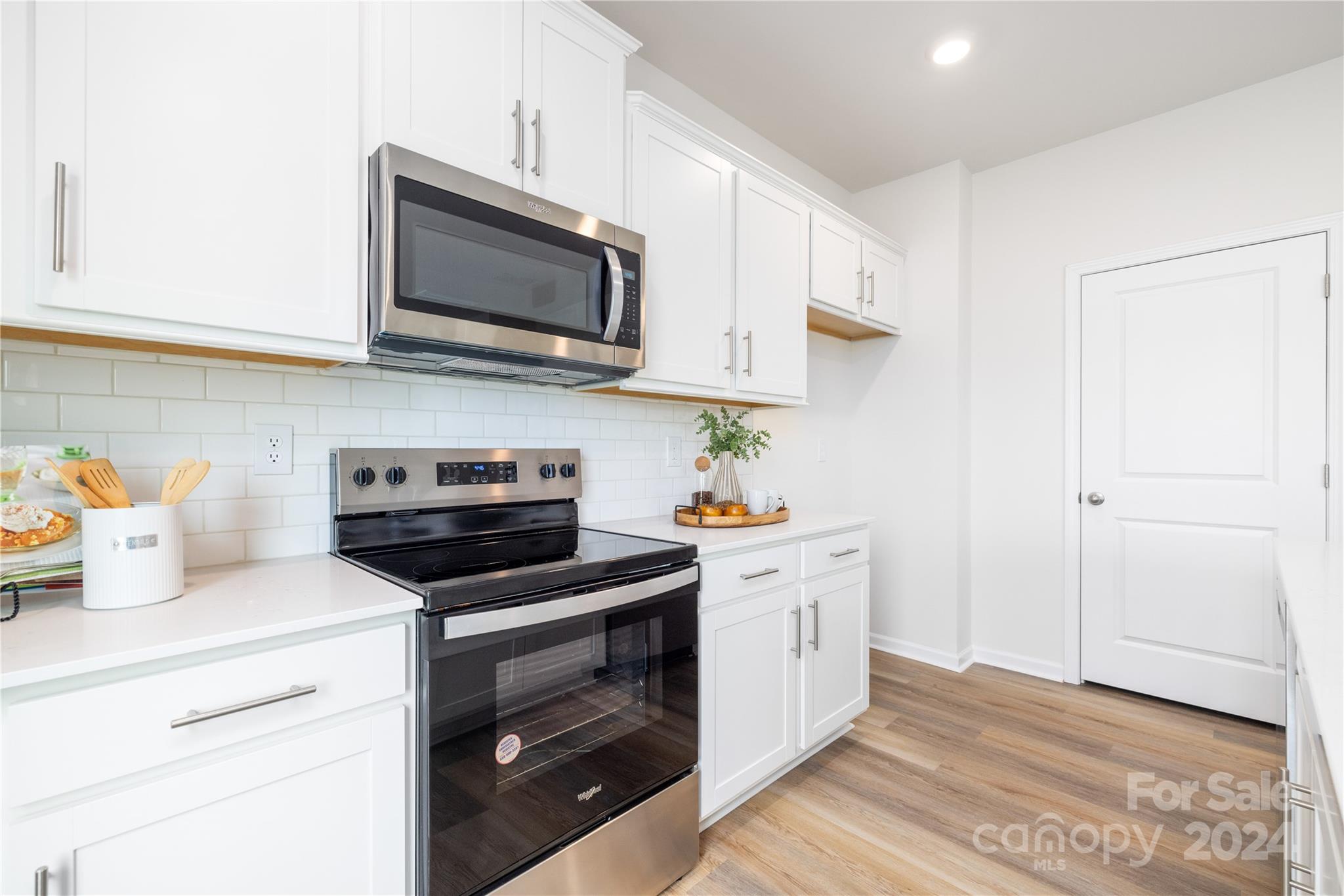 7910 Old Brk Road Sherrills Ford, NC 28673 - Photo 12 of 24 a kitchen with stainless steel appliances a stove a microwave and cabinets