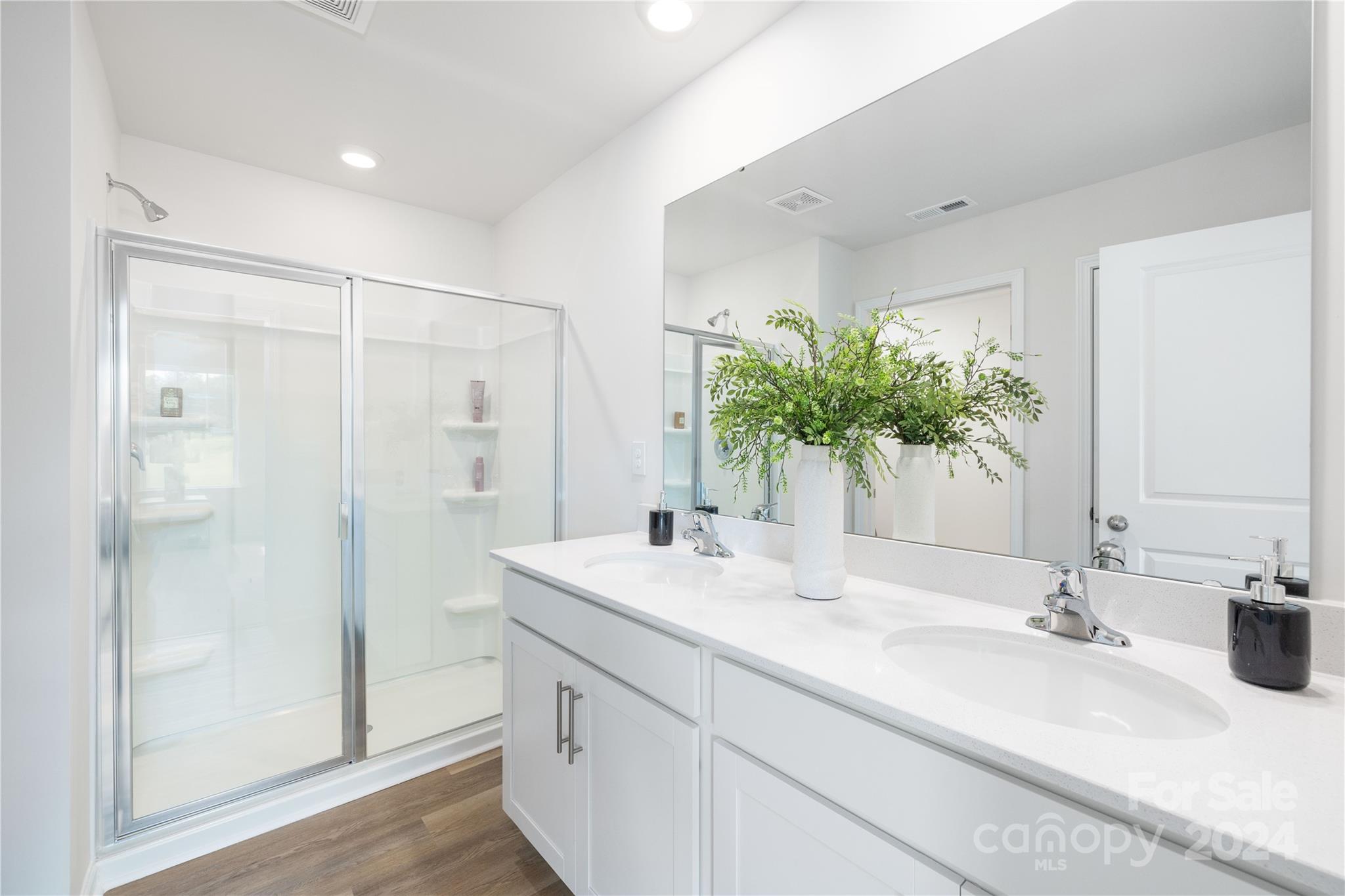 7910 Old Brk Road Sherrills Ford, NC 28673 - Photo 16 of 24 a bathroom with a granite countertop sink a mirror and a shower