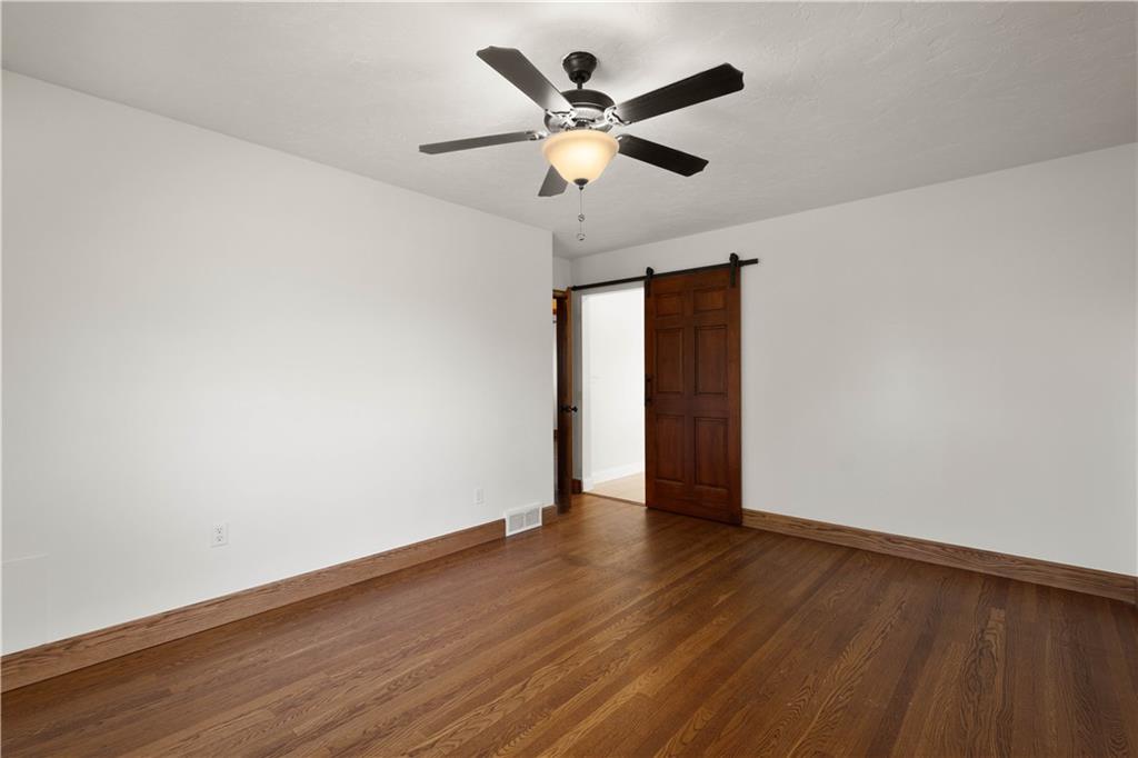 330 Center Grange Road Monaca, PA 15061 - Photo 13 of 26 an empty room with wooden floor and ceiling fan