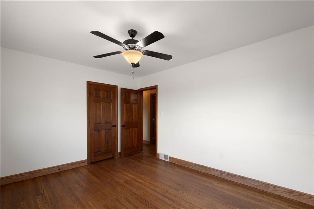 330 Center Grange Road Monaca, PA 15061 - Photo 14 of 26 an empty room with wooden floor chandelier fan and windows