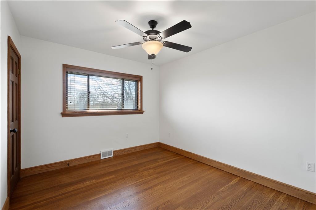 330 Center Grange Road Monaca, PA 15061 - Photo 15 of 26 a view of an empty room with wooden floor and a ceiling fan
