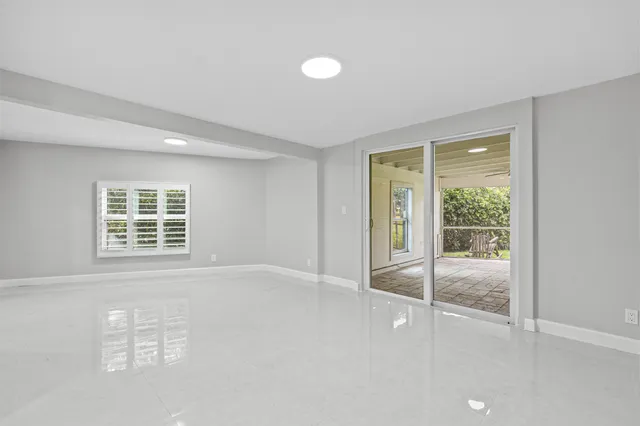 a view of an empty room with glass door