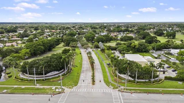 an aerial view of residential houses with outdoor space and swimming pool