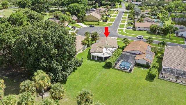 an aerial view of a house with garden space and street view