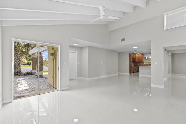 a view of a hallway with wooden floor and a cabinet
