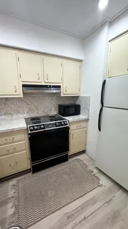 a kitchen with a stove and a refrigerator