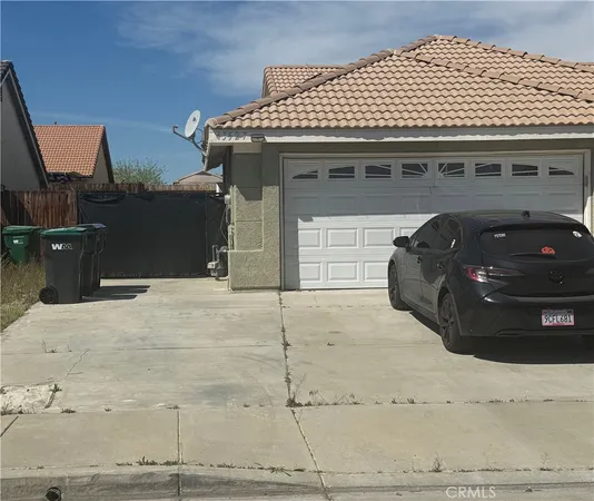 a black car parked in front of a house