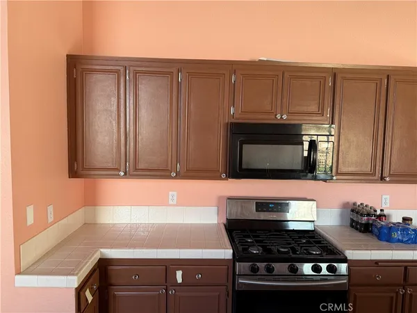 a kitchen with granite countertop a stove and a sink