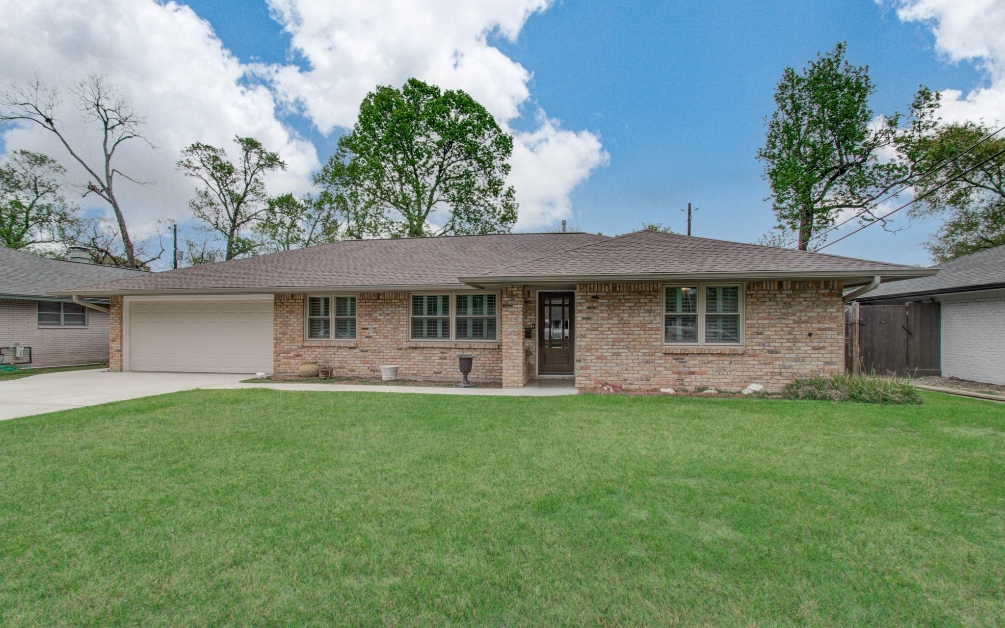 9002 Railton Street Houston, TX 77080 - Photo 1 of 32 a front view of a house with a garden