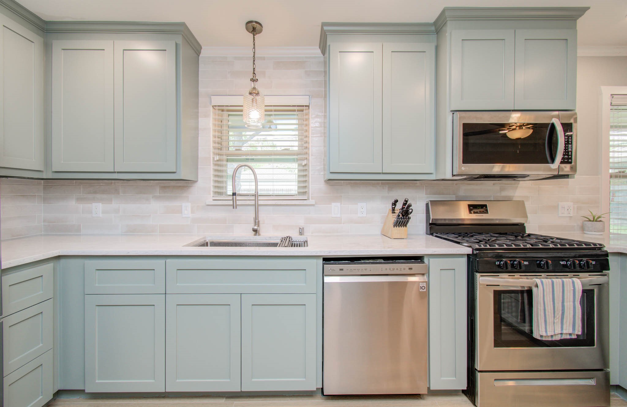 9002 Railton Street Houston, TX 77080 - Photo 11 of 32 a kitchen with white cabinets appliances and sink