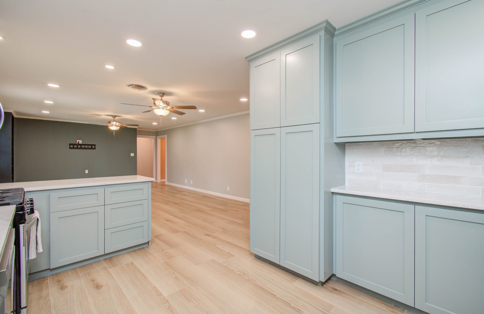 9002 Railton Street Houston, TX 77080 - Photo 12 of 32 a view of a kitchen with a sink and dishwasher with wooden floor