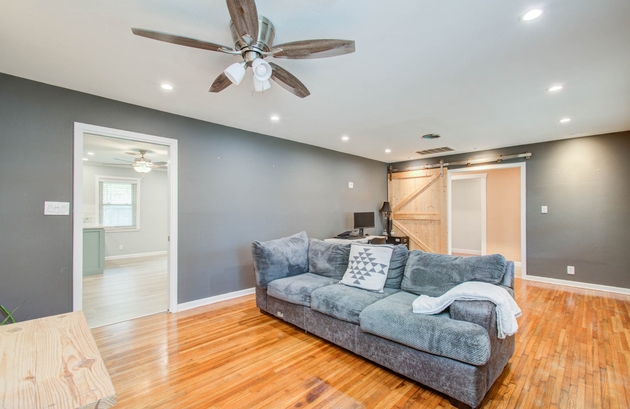 9002 Railton Street Houston, TX 77080 - Photo 16 of 32 a living room with furniture and a ceiling fan