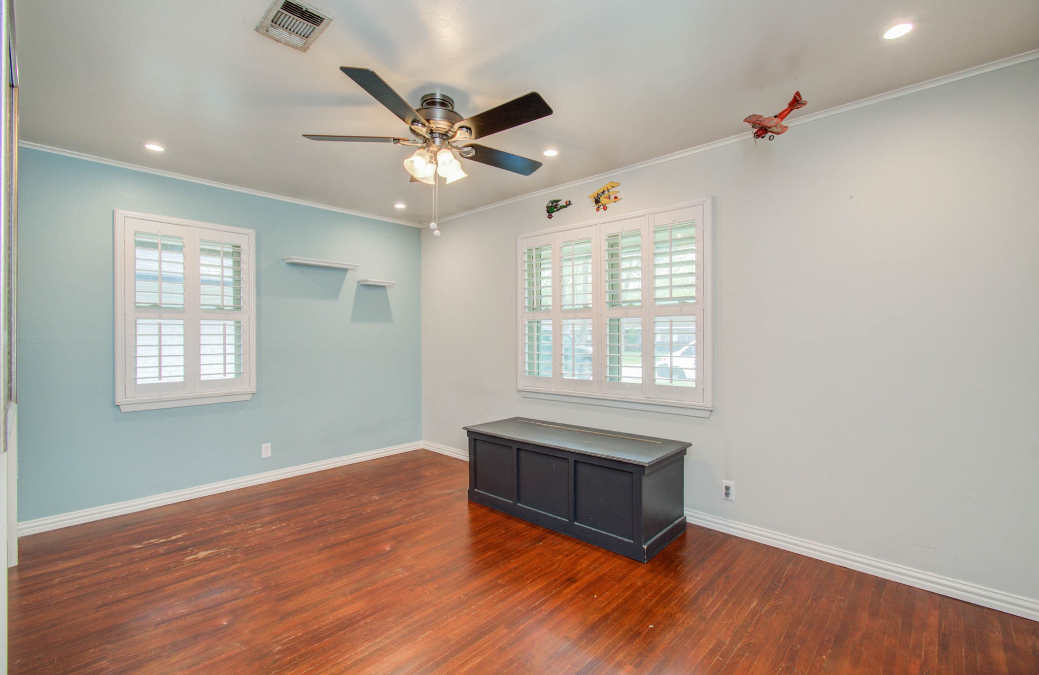 9002 Railton Street Houston, TX 77080 - Photo 18 of 32 an empty room with wooden floor fan and windows