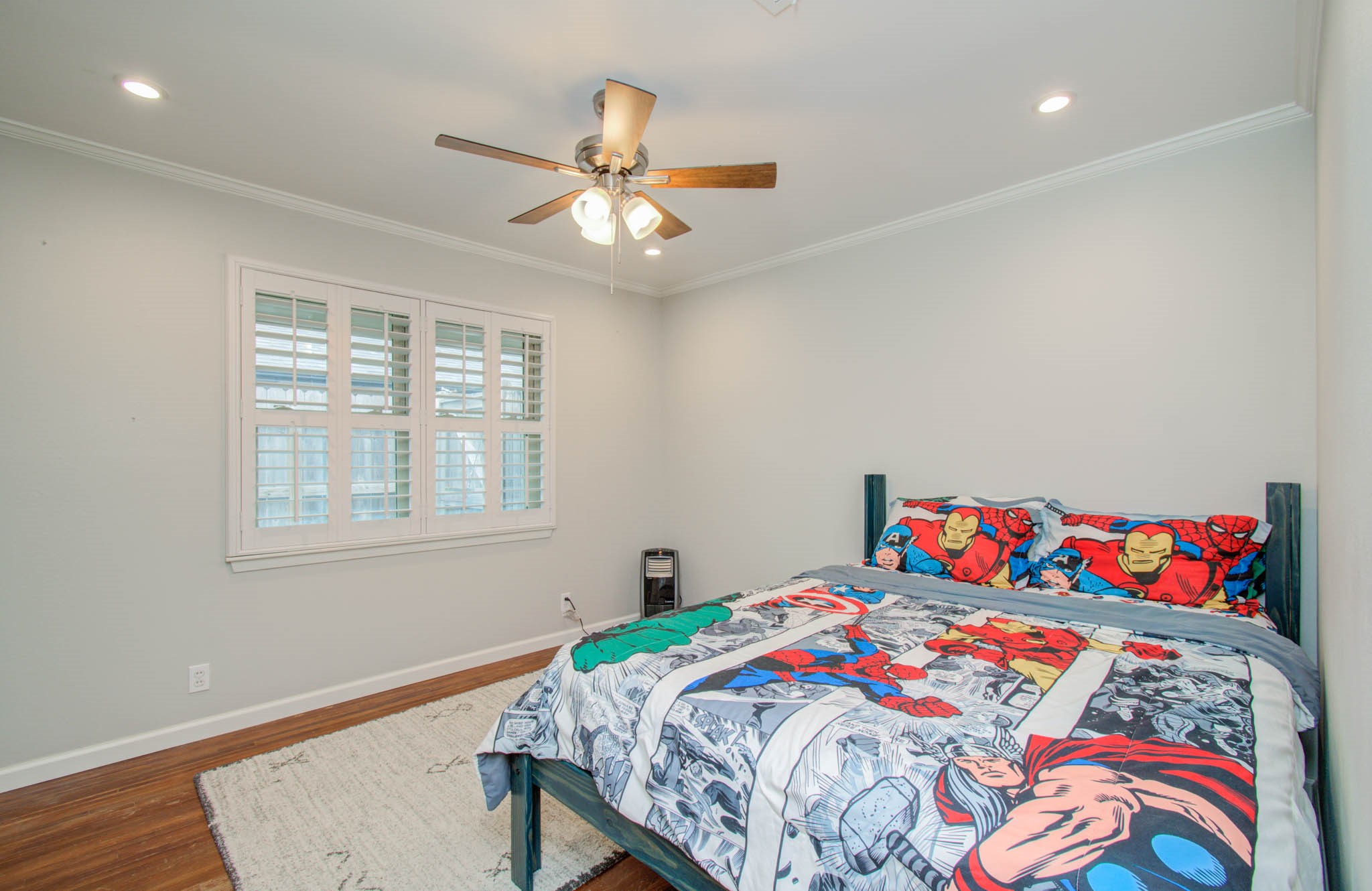 9002 Railton Street Houston, TX 77080 - Photo 20 of 32 a bedroom with a bed and a chandelier
