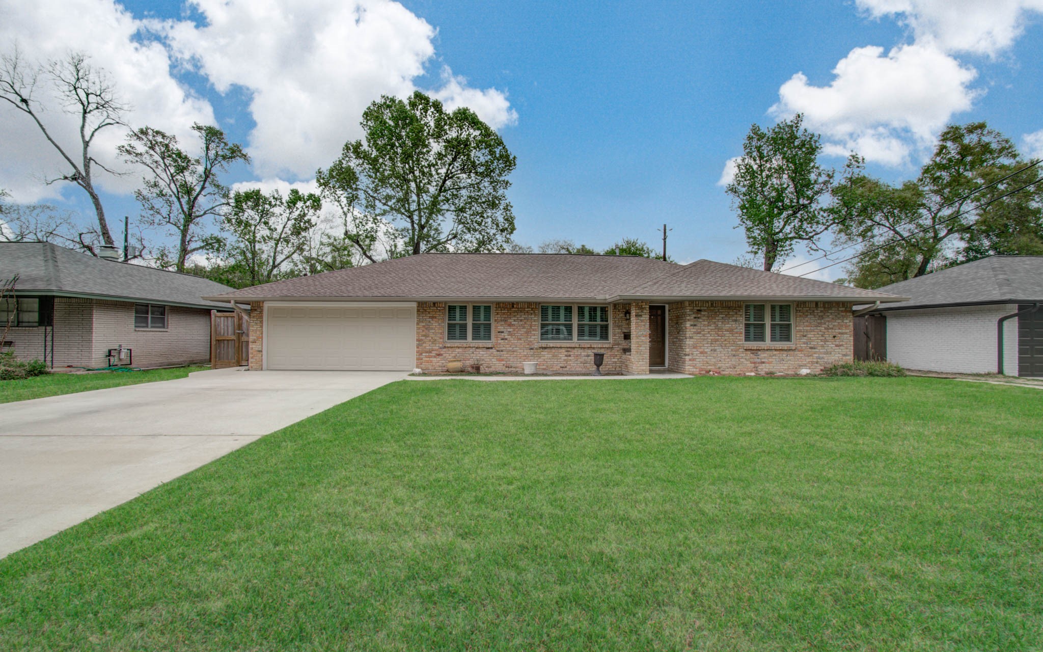 9002 Railton Street Houston, TX 77080 - Photo 2 of 32 a front view of a house with a garden