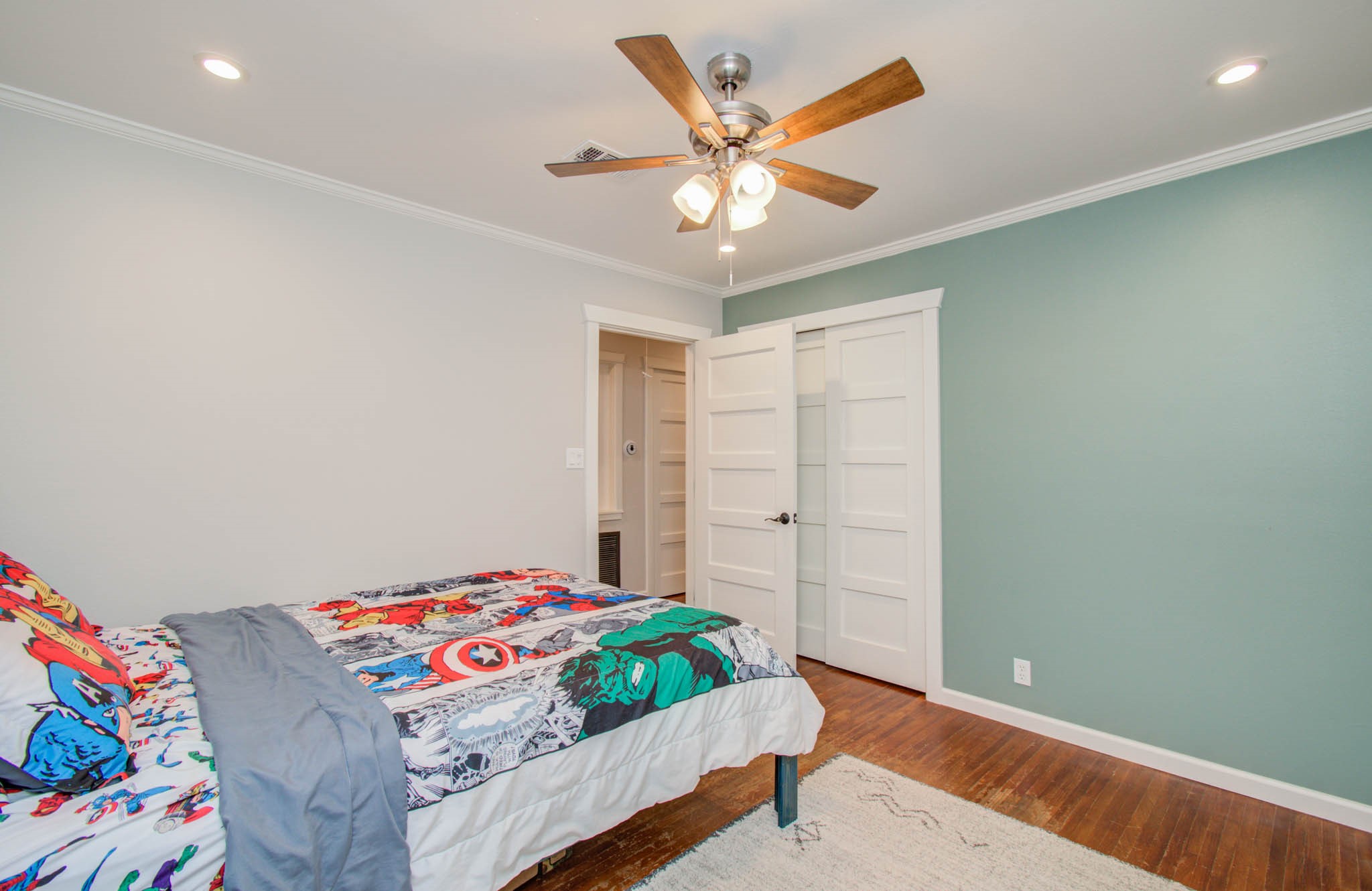 9002 Railton Street Houston, TX 77080 - Photo 21 of 32 a bedroom with a bed and a chandelier