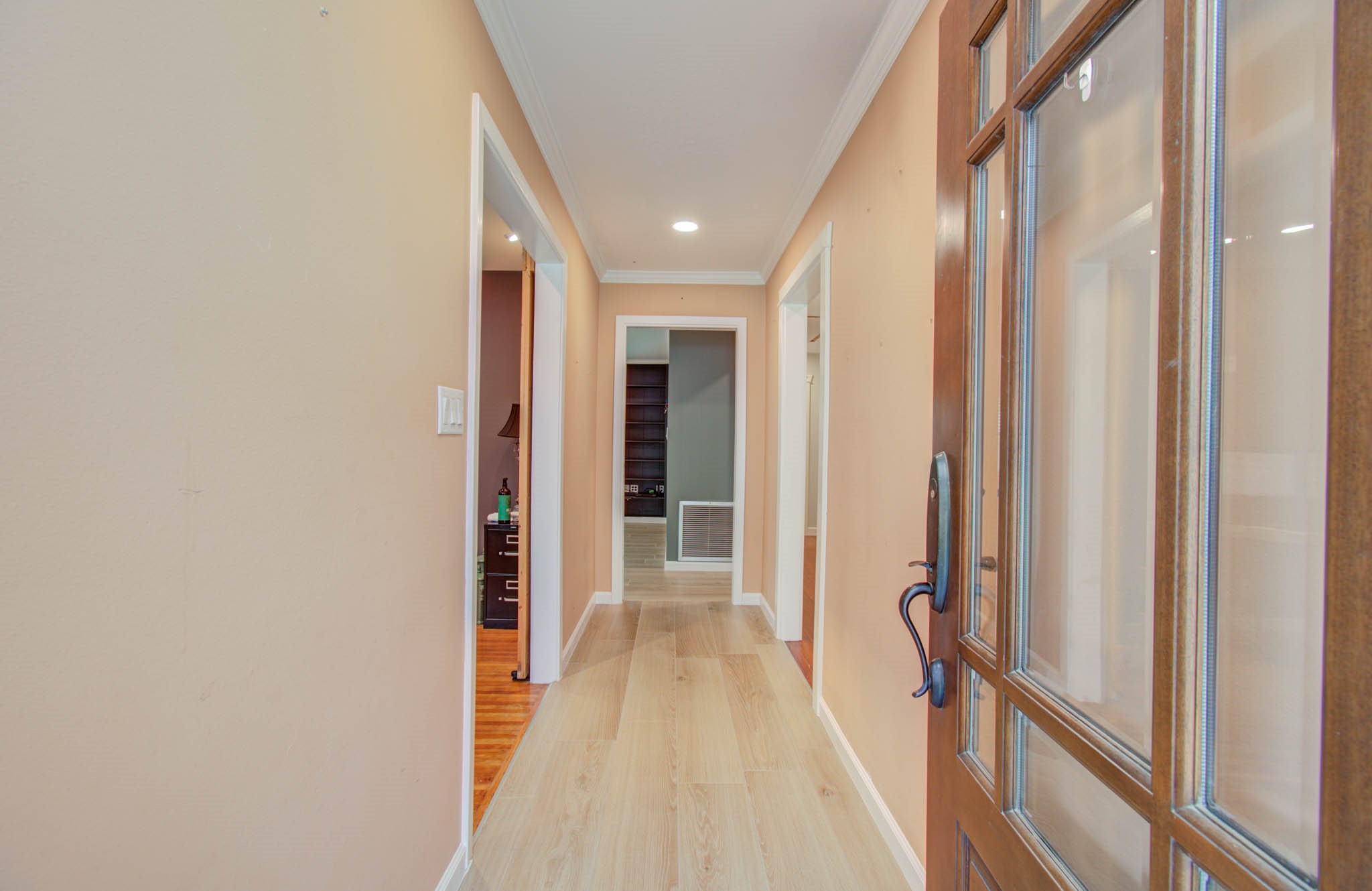 9002 Railton Street Houston, TX 77080 - Photo 4 of 32 a view of a hallway with wooden floor and staircase