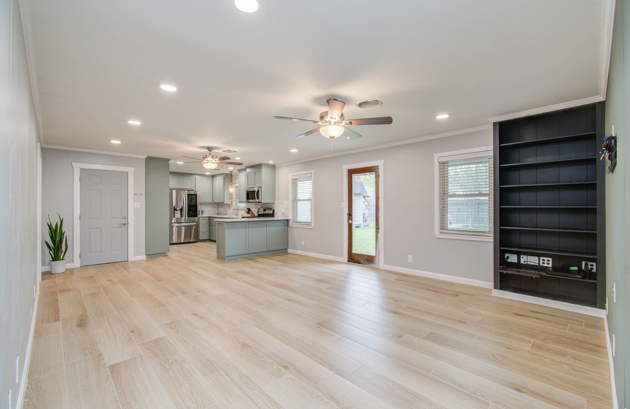 9002 Railton Street Houston, TX 77080 - Photo 5 of 32 a view of an empty room with a window and wooden floor