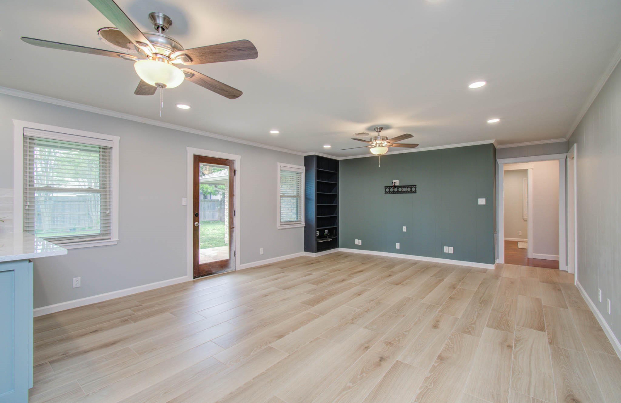 9002 Railton Street Houston, TX 77080 - Photo 7 of 32 a view of an empty room with window and wooden floor