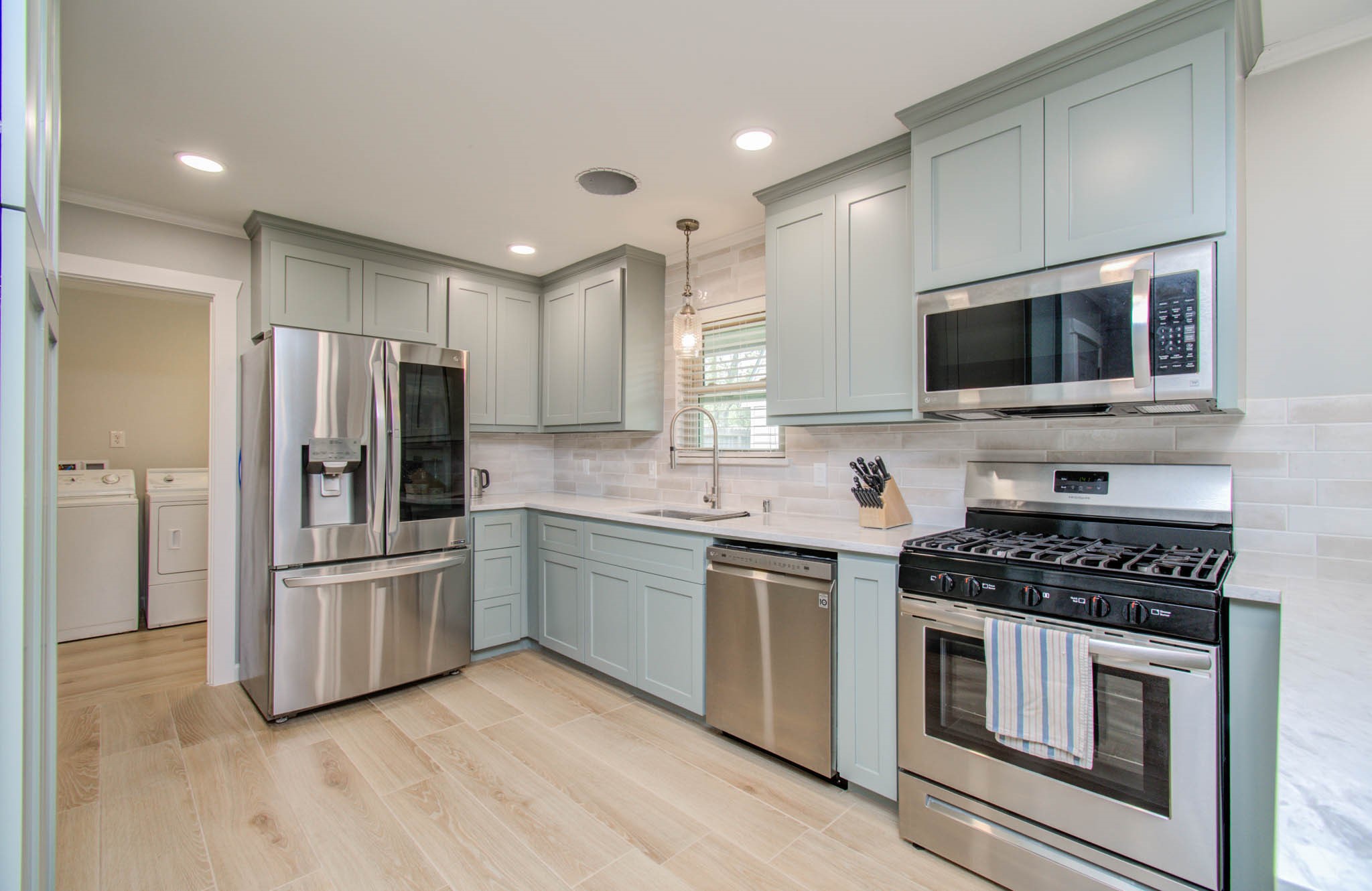 9002 Railton Street Houston, TX 77080 - Photo 9 of 32 a kitchen with stainless steel appliances a refrigerator stove and microwave