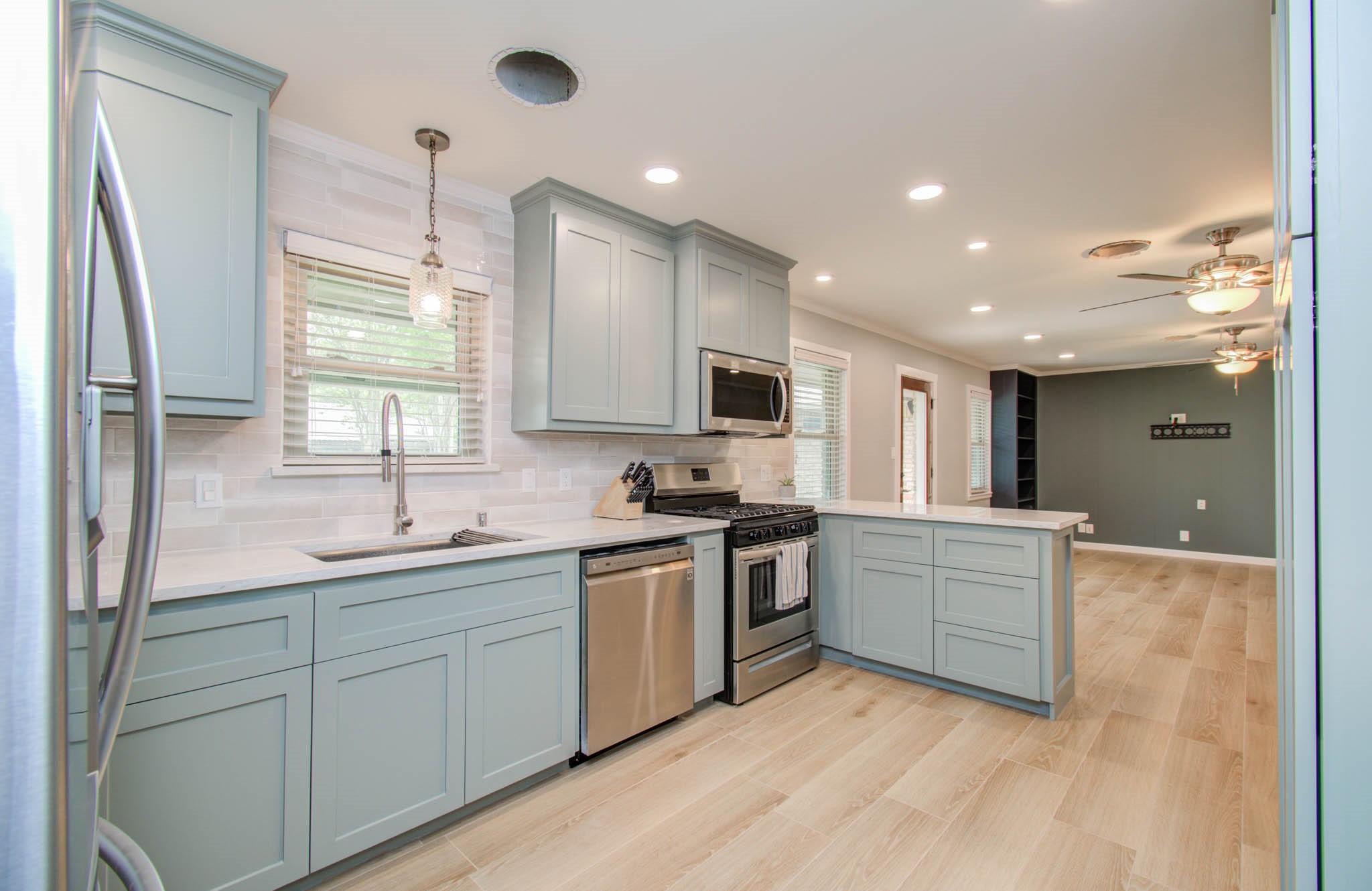 9002 Railton Street Houston, TX 77080 - Photo 10 of 32 a kitchen with white cabinets appliances and a sink