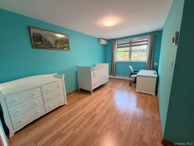 150-06 78th Road Queens, NY 11367 - Photo 17 of 22 a room with furniture and a wooden floor