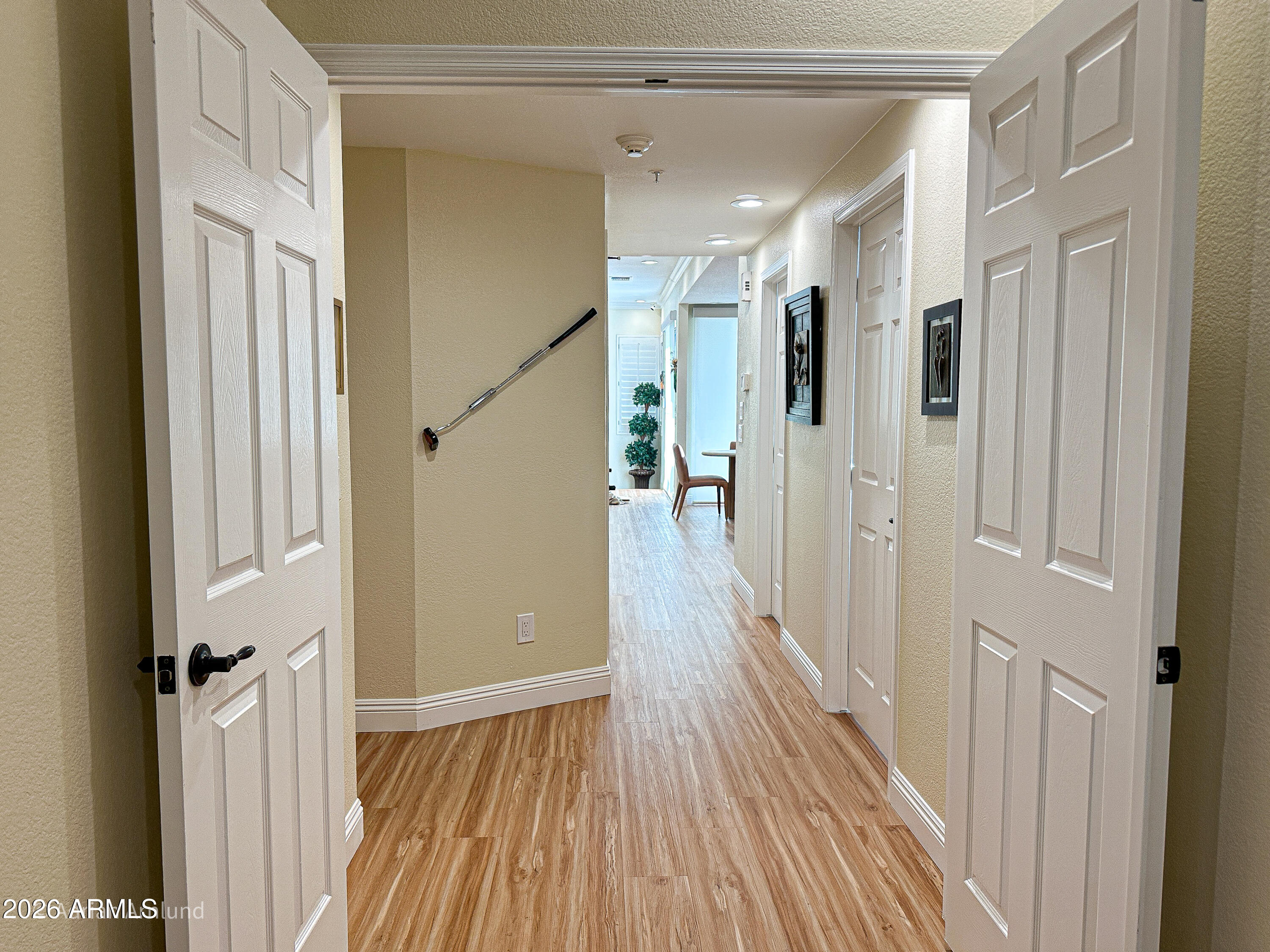 7222 East Gainey Ranch Road, Unit 224 Scottsdale, AZ 85258 - Photo 15 of 42 a view of a hallway with wooden floor and staircase