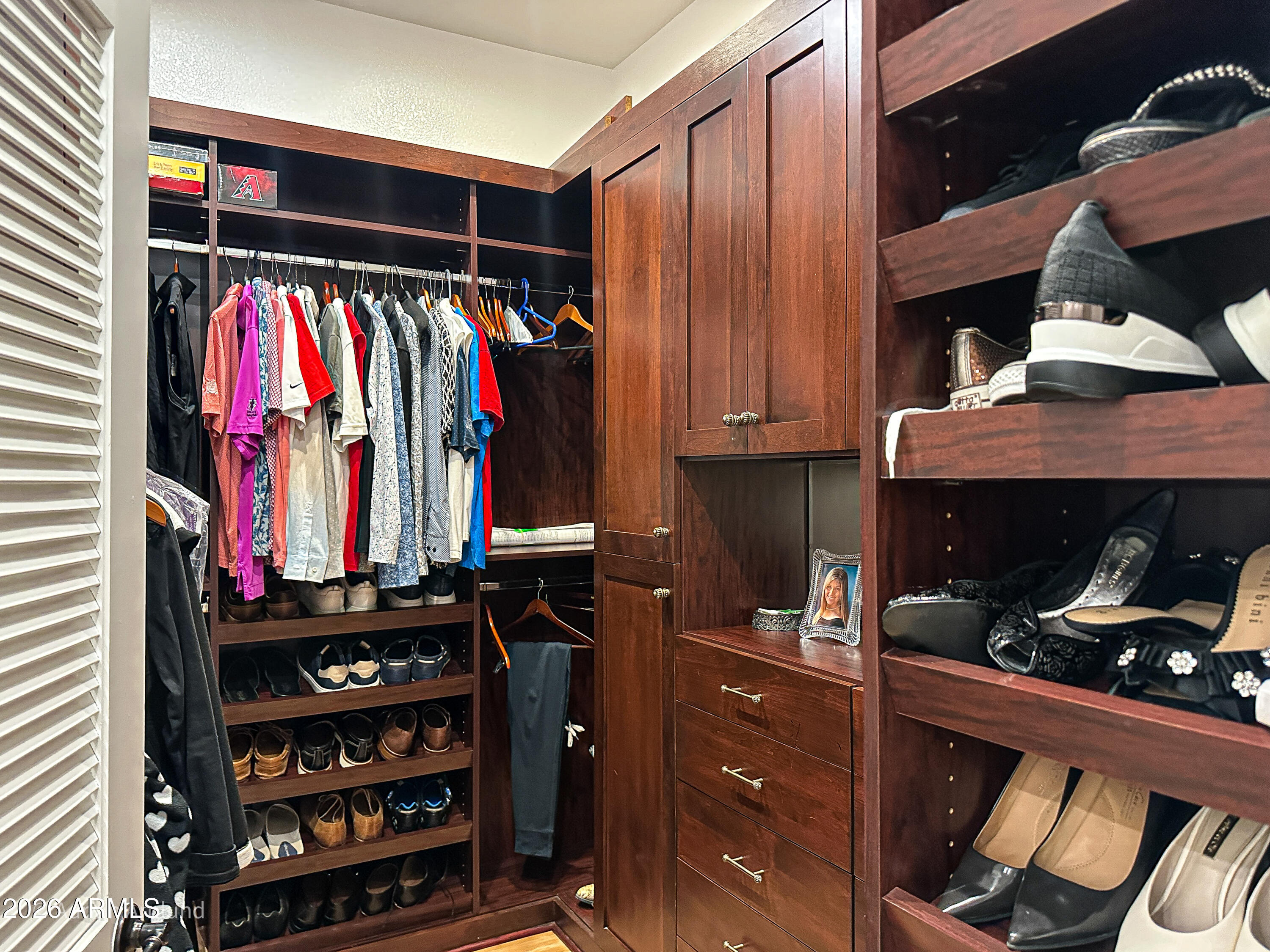 7222 East Gainey Ranch Road, Unit 224 Scottsdale, AZ 85258 - Photo 24 of 42 a view of walk in closet with clothes and shoes
