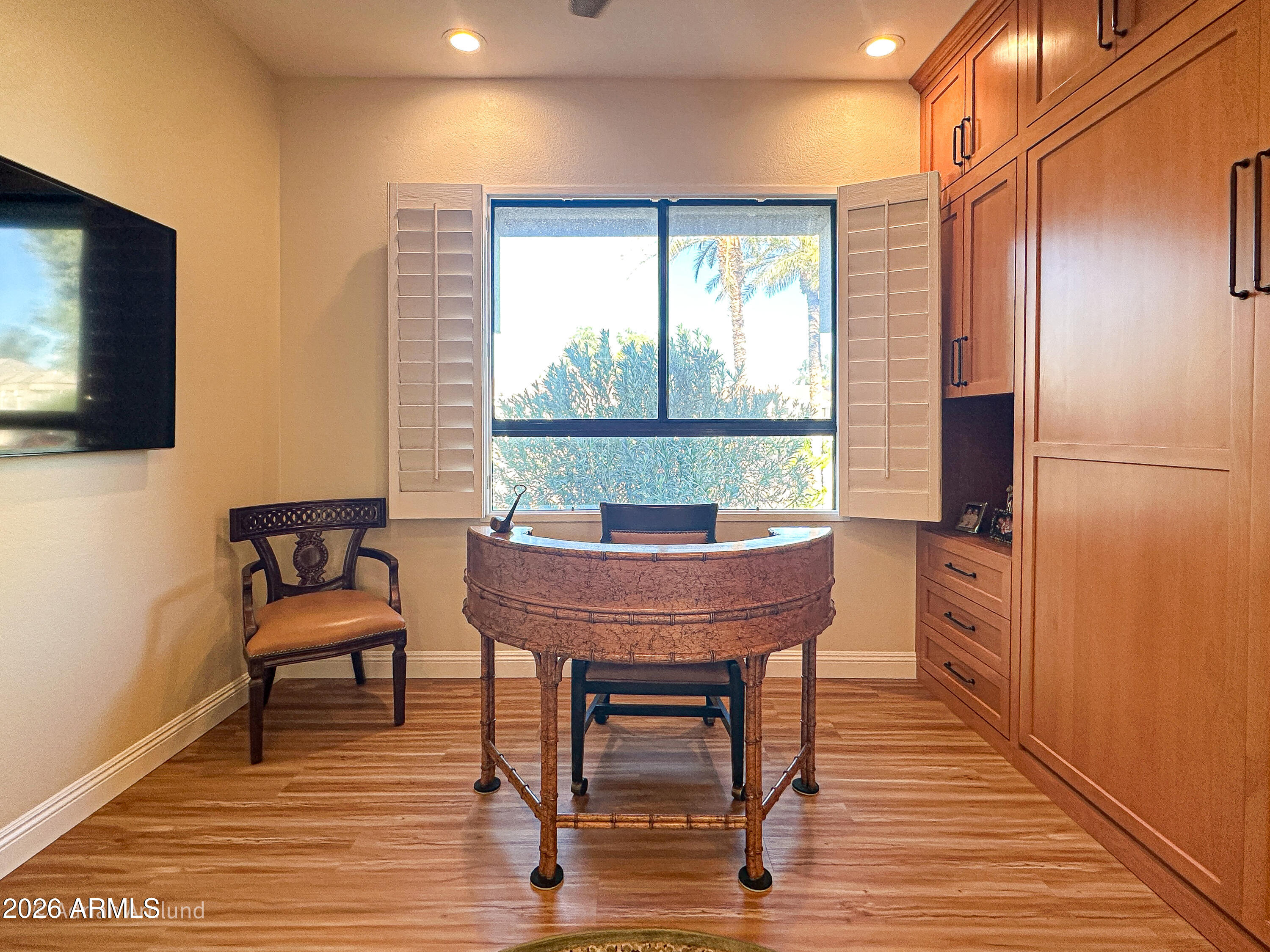 7222 East Gainey Ranch Road, Unit 224 Scottsdale, AZ 85258 - Photo 30 of 42 a view of a dining room with furniture window and wooden floor