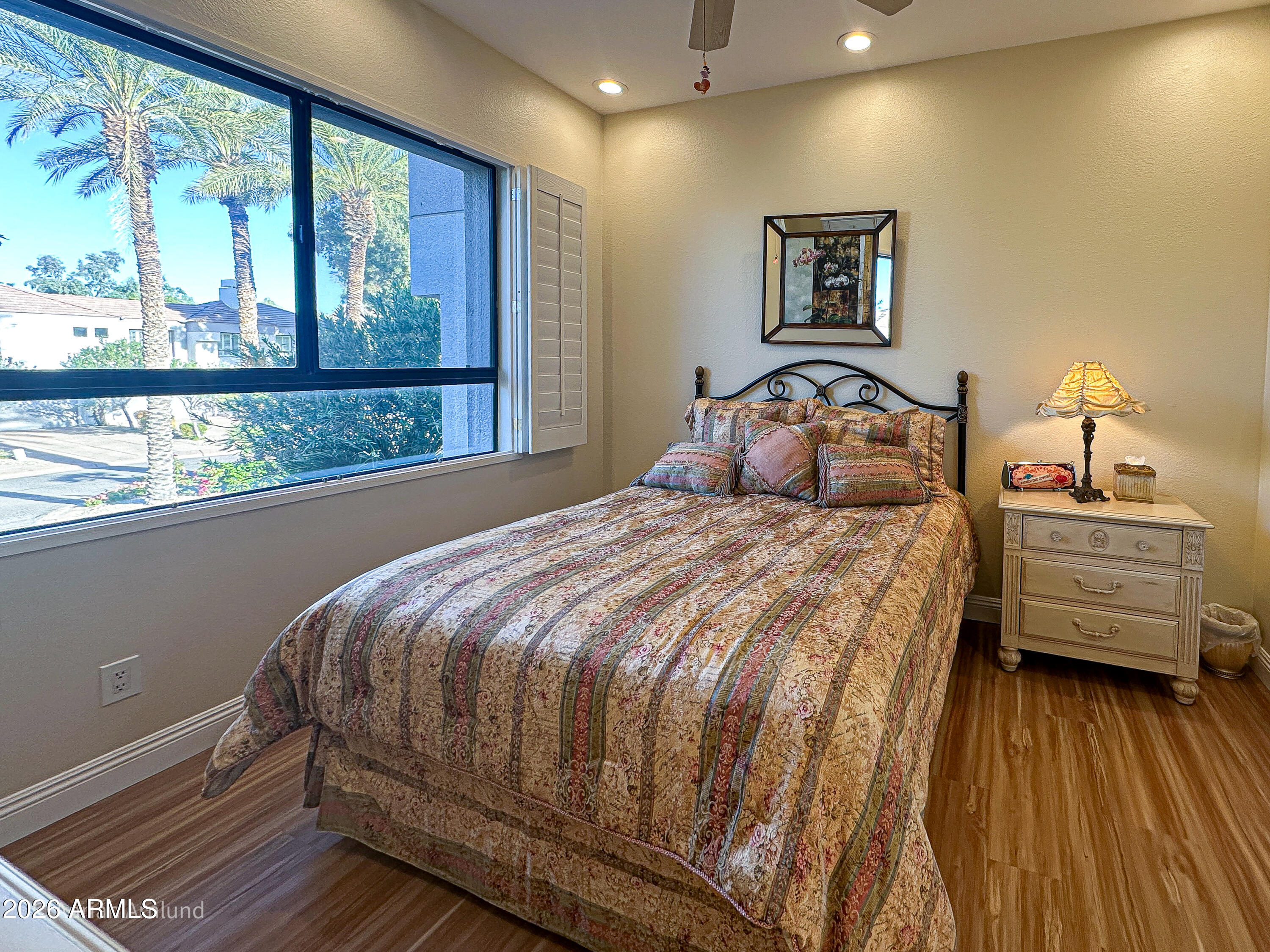 7222 East Gainey Ranch Road, Unit 224 Scottsdale, AZ 85258 - Photo 32 of 42 a bedroom with a bed and a large window