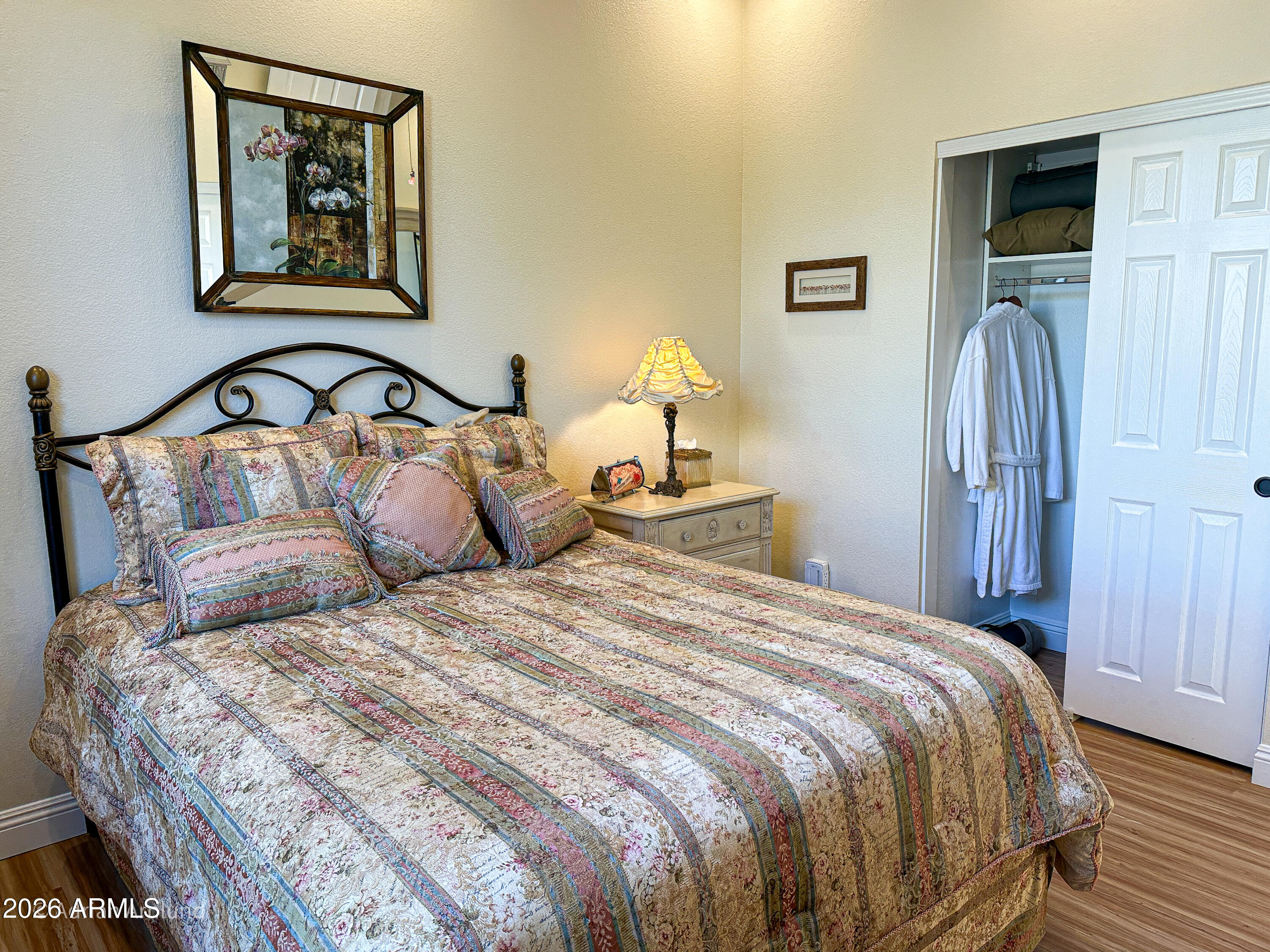 7222 East Gainey Ranch Road, Unit 224 Scottsdale, AZ 85258 - Photo 33 of 42 a bedroom with a bed and a painting on the wall