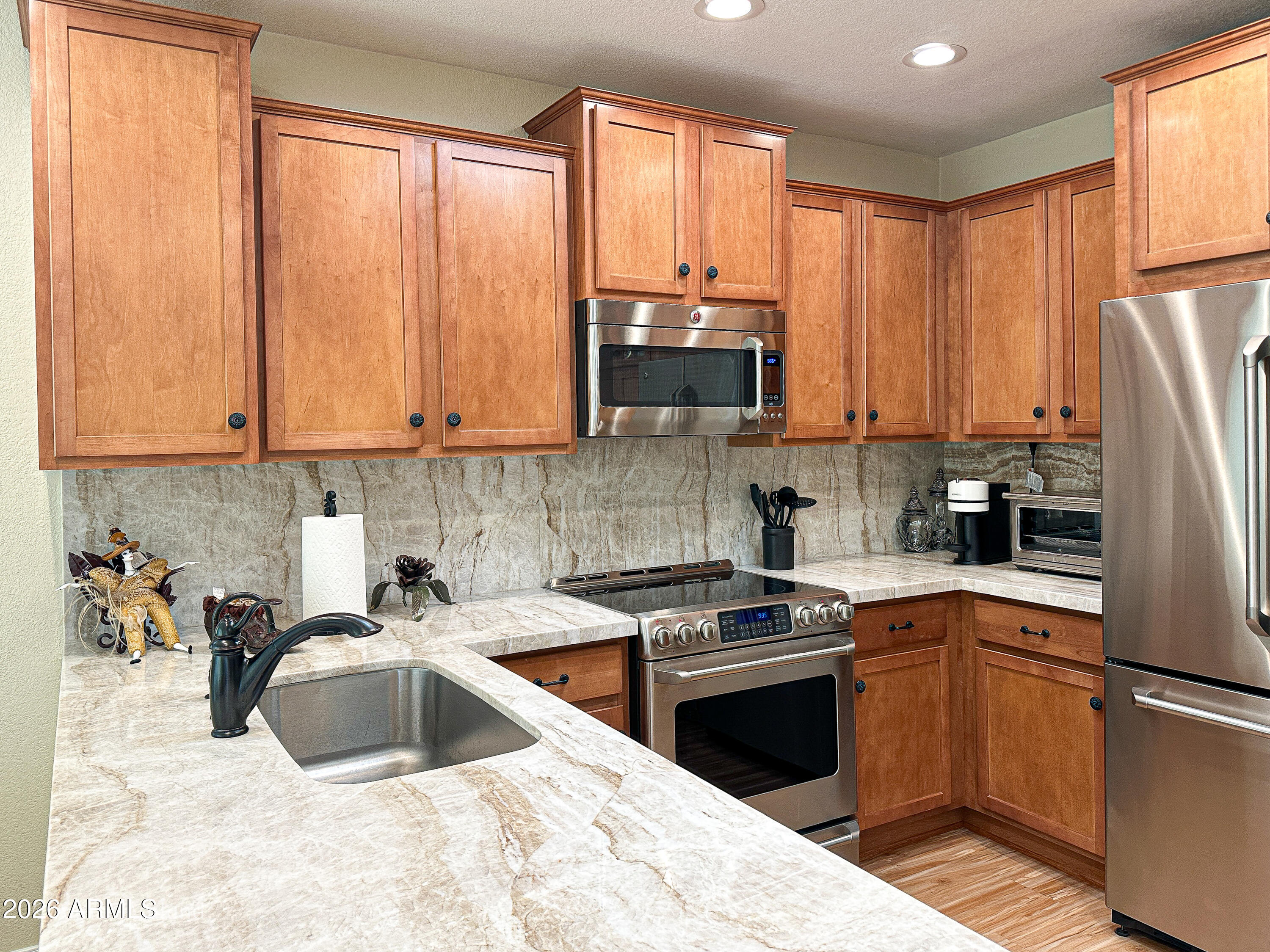 7222 East Gainey Ranch Road, Unit 224 Scottsdale, AZ 85258 - Photo 7 of 42 a kitchen with a sink a refrigerator and a stove