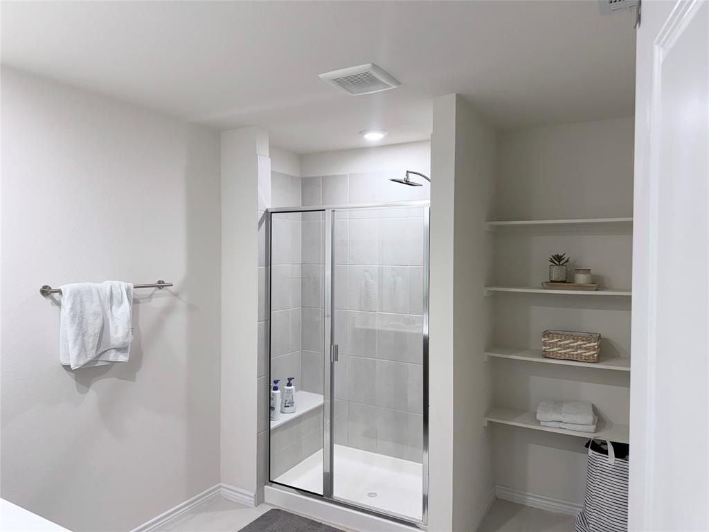 1602 Maple Ridge Drive Princeton, TX 75407 - Photo 7 of 13 Enclosed shower with a built-in bench, glass door, and tile surround